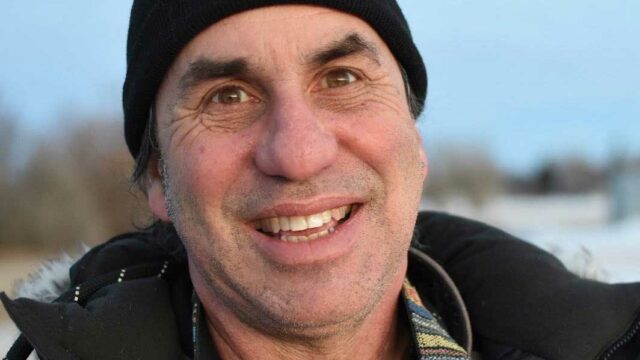 Photo of man smiling wearing a hat