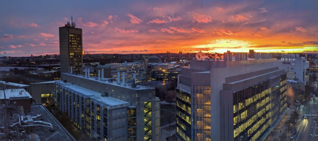 View over the MIT campus at sunset. In the foreground are the Koch Biology Building and Koch Institute.